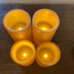 4 gold glitter frameless candles. 6” and 4” tall. Varied controls with remote